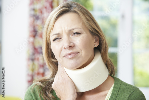 Woman Wearing Surgical Collar In Pain