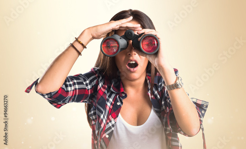 Surprised woman with binoculars