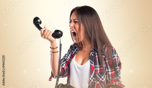 Woman shouting to vintage phone