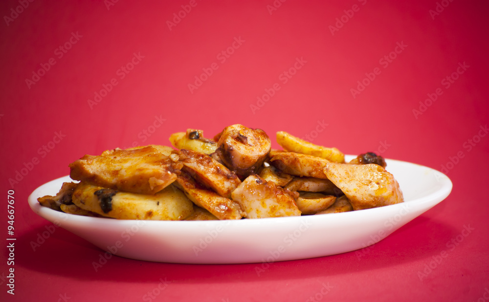 Octopus with paprika on a white plate, also known as Galician oc Octopus with paprika on a white plate, also known as Galician oc