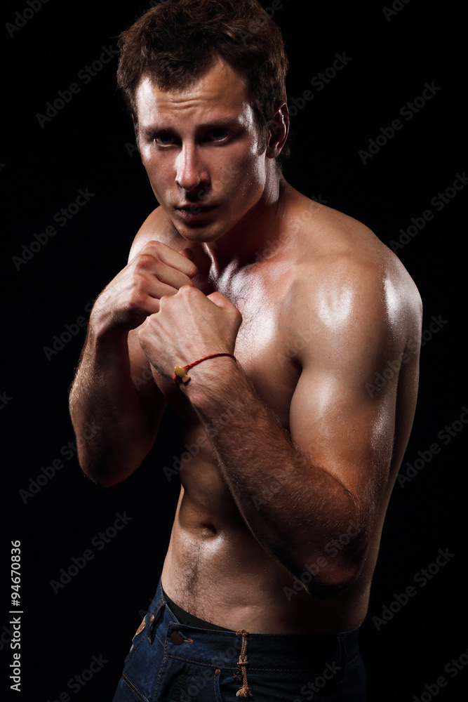 Portrait of a man in a fighting stance.