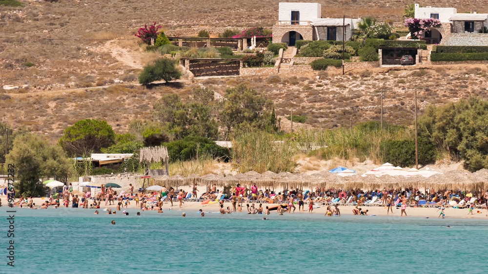  Local people and tourists enjoying their summer vacations at famous Marchello beach in Paros island. - obrazy, fototapety, plakaty 