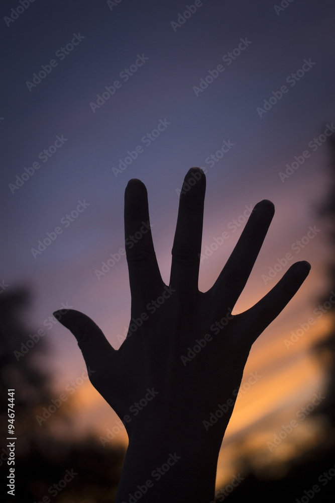 Fingers of hands at dusk silhouette sunset sky