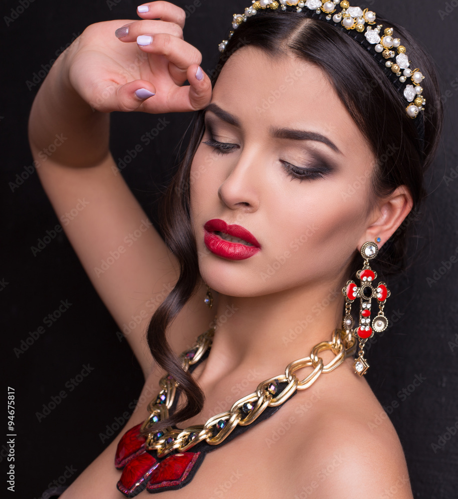 gorgeous woman with dark hair and bright makeup with luxurious b