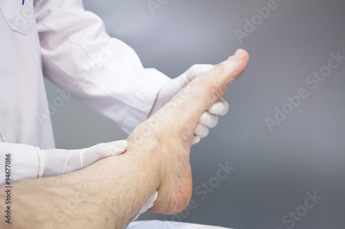 Traumatologist orthopedic surgeon doctor examining patient