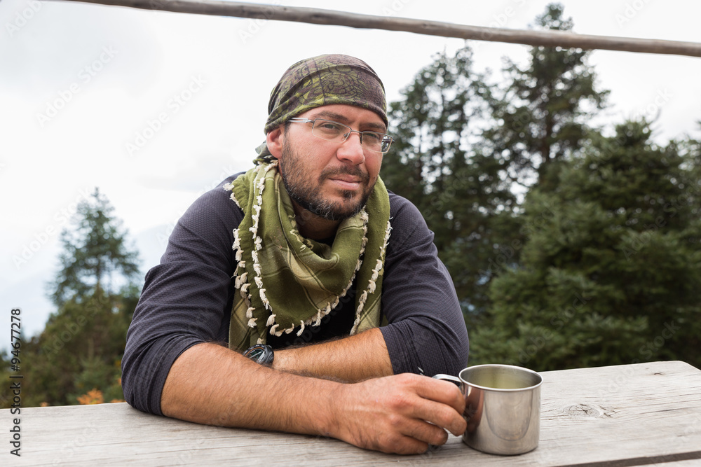 Backpacker tourist mountaineer man portrait sitting resting. Backpacker tourist mountaineer man portrait sitting resting.