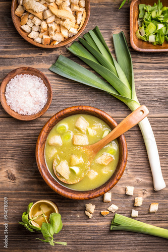 Delicious leek soup in wooden bowl