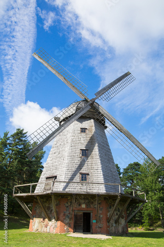 Old windmill near the forest in summer.