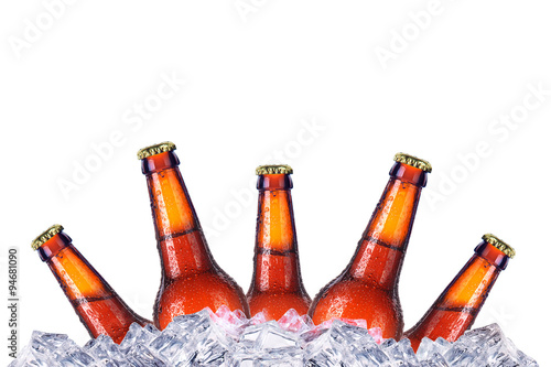 Set of beer's bottles with frosty drops in ice