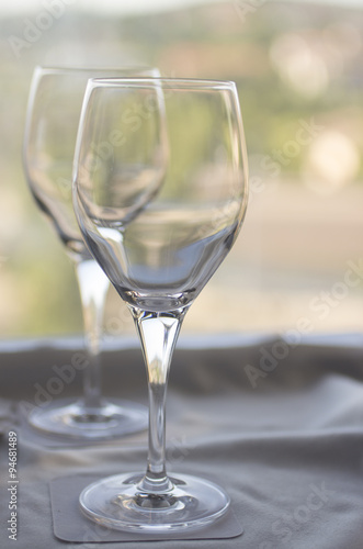 Wine or water glasses on coasters on cloth on tray