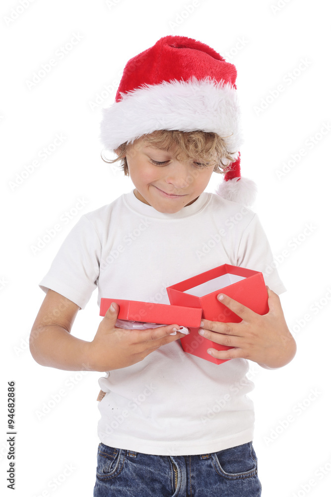 enfant garçon 6 ans avec bonnet de Noël ouvrant cadeau Photos | Adobe Stock
