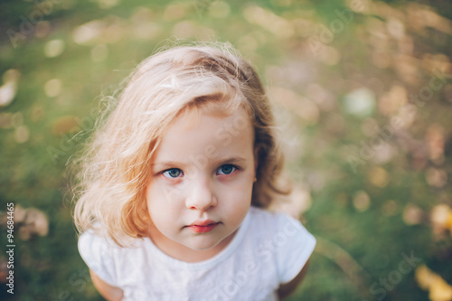 portrait of a little blond girl outdoors