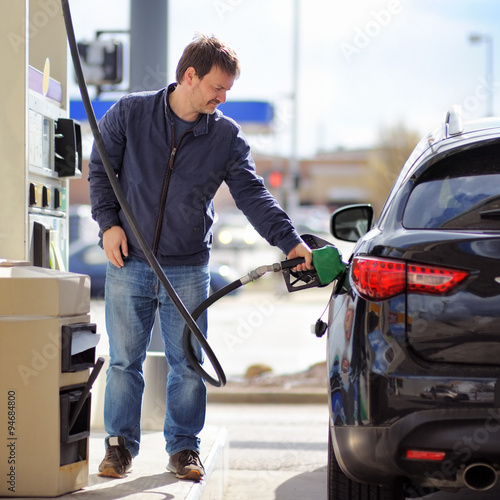 Man filling gasoline fuel in car