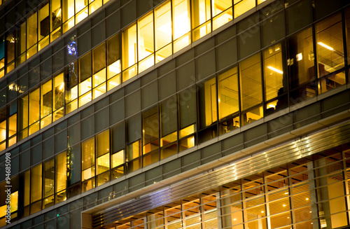 Office building windows lit up at night