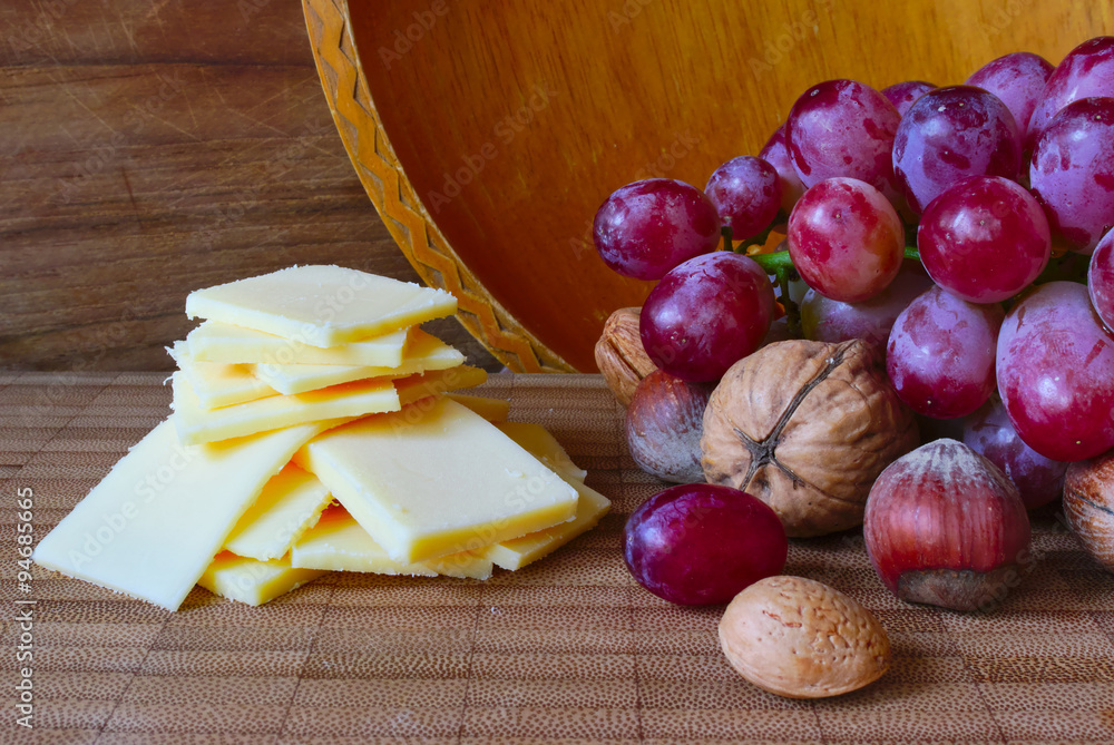 Cheese and grapes on a board