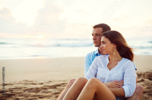 Couple Relaxing on the Beach Watching the Sunset