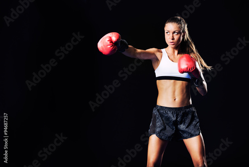 Beautiful Fitness Woman Boxing with Red Gloves