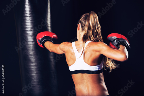 Beautiful Fitness Woman Boxing with Red Gloves