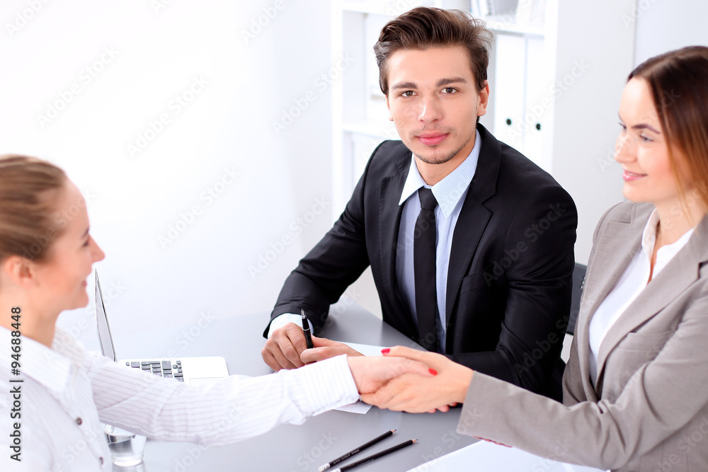 Business people shaking hands, finishing up a meeting. Copy space at the left corner Business people shaking hands, finishing up a meeting. Copy space at the left corner