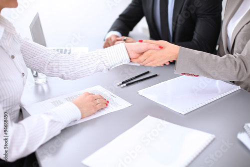 Business people shaking hands, finishing up a meeting. Copy space at the left corner