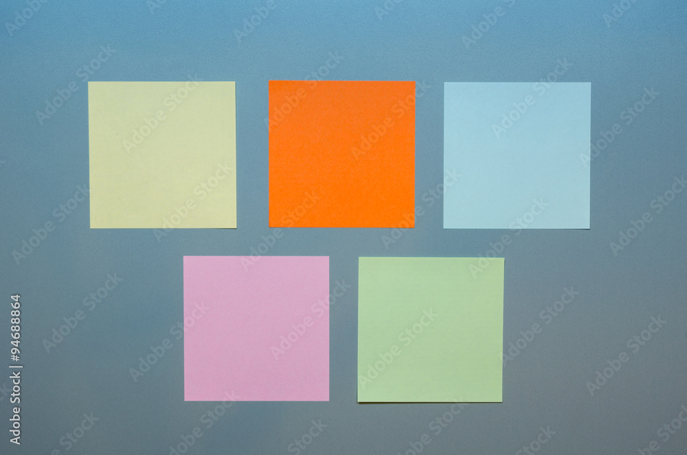 Five colored empty reminders on a grey panel Five colored empty reminders on a grey panel