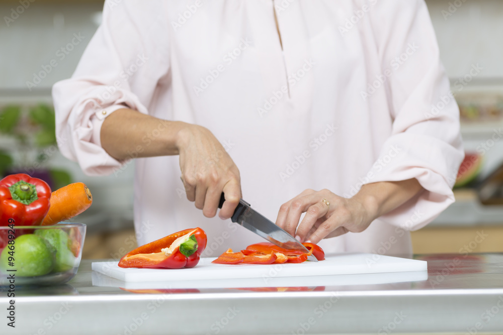 Closeup on woman cutting fresh vegetables