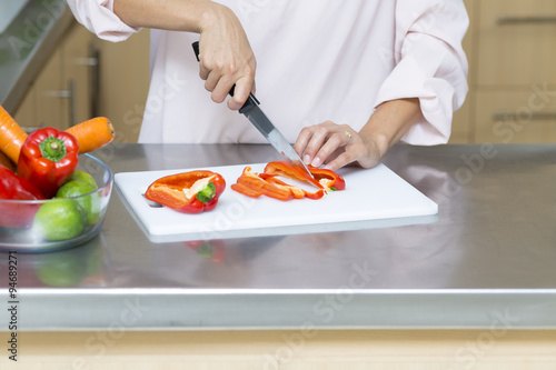 Closeup on woman cutting fresh vegetables