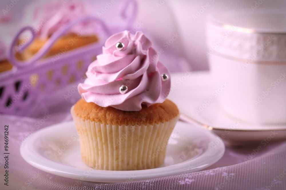 Tasty cupcake on saucer, on light background Tasty cupcake on saucer, on light background