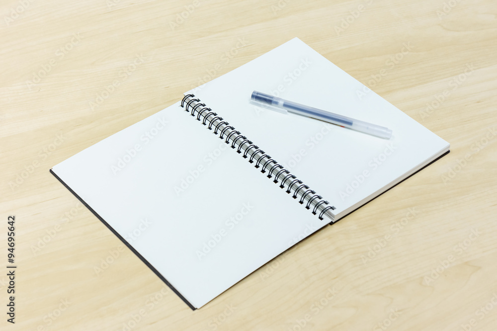 pen and notebook on wooden desk pen and notebook on wooden desk