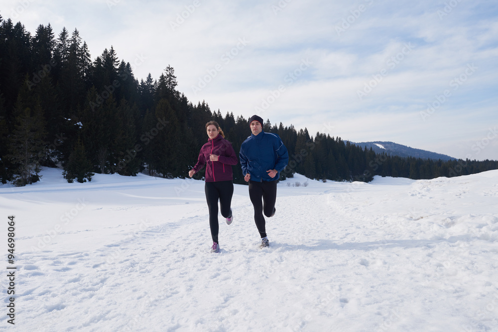 couple jogging outside on snow
