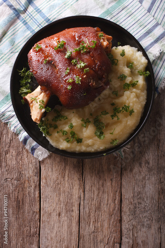 baked pork knuckle and mashed potatoes closeup. vertical top view
 photo