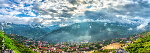 Sunrise on the town of Coc Pai as the sun rays to the town was still asleep when the dew is still on-going spread of the mountain, the sun shines through clouds beautifully down tranquil countryside