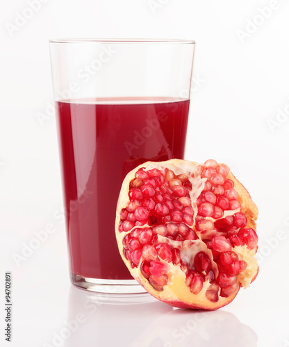 glass of juice and pieces of pomegranate