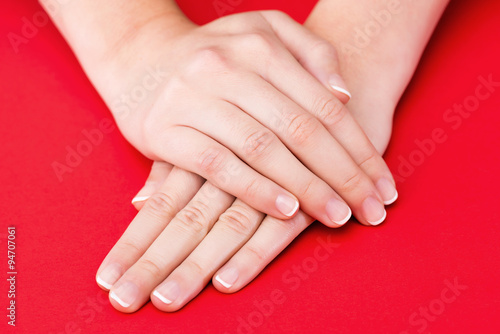 Beautiful Female Hands on red background
