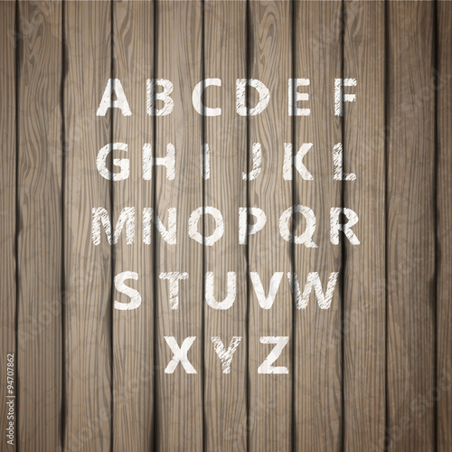 Grunge full alphabet on old wooden board. Vector
