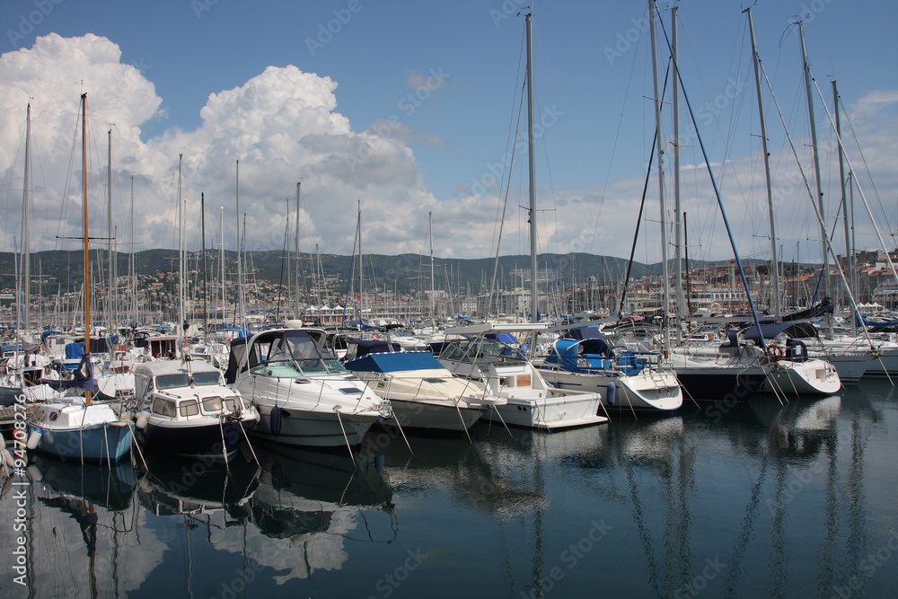 Motor boats and sailboats in harbor in Trieste, Italy