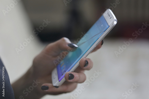 Woman using new mobile phone with one hand