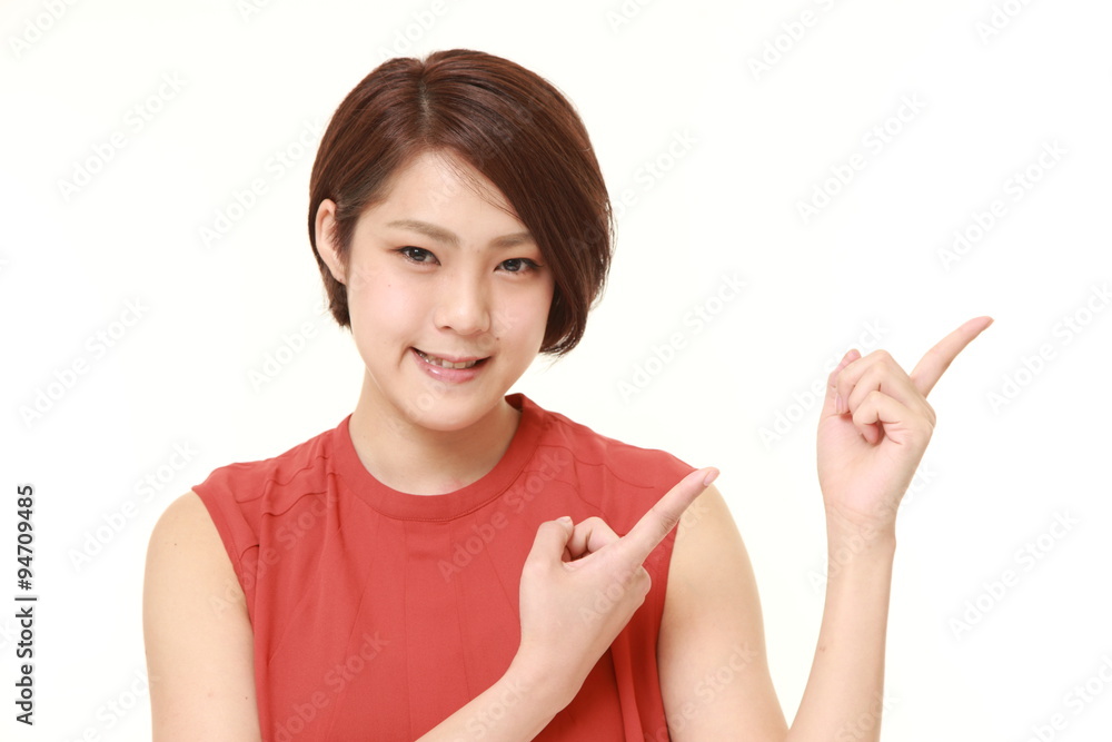 young Japanese woman presenting and showing something young Japanese woman presenting and showing something