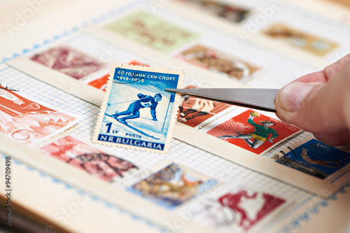 Postage stamp with skier on album photo