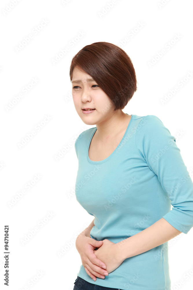 young Japanese woman suffers from stomachache young Japanese woman suffers from stomachache