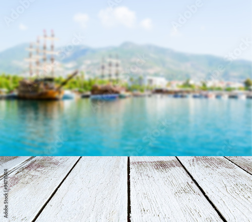 Seascape, ships and mountains blurred, wooden plank in perspective © binik