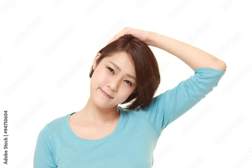 young woman doing self neck stretch young woman doing self neck stretch