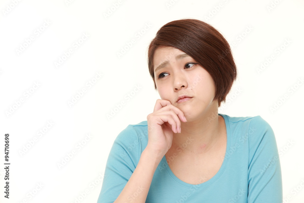 young Japanese woman worries about something young Japanese woman worries about something