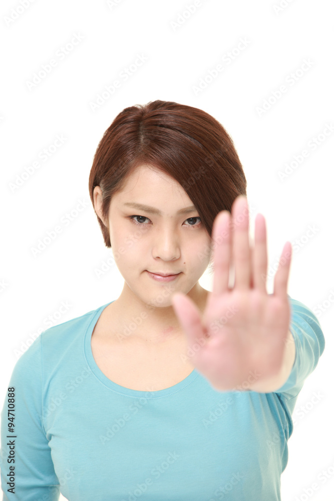 young Japanese woman making stop gesture young Japanese woman making stop gesture