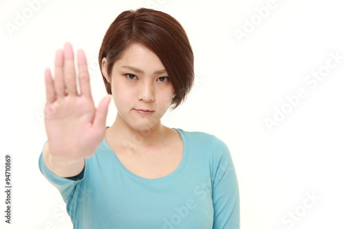Wallpaper Mural  young Japanese woman making stop gesture Torontodigital.ca