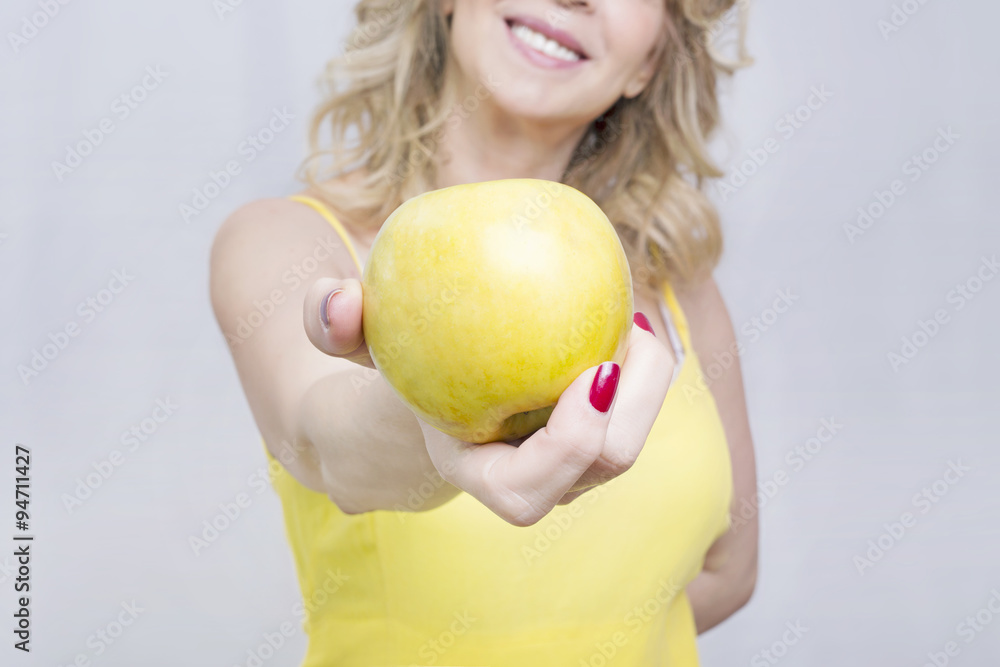 Happy and healthy woman showing an apple Happy and healthy woman showing an apple