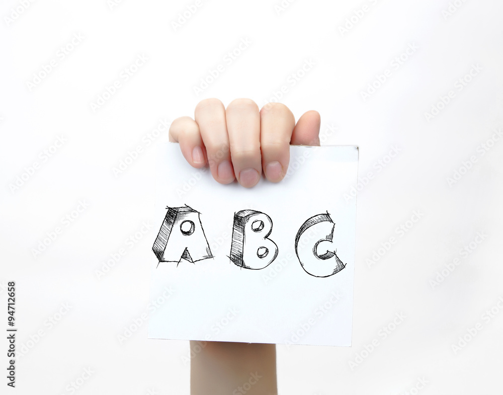 Hand holding a piece of paper with sketchy capital letters ABC, isolated on white. Hand holding a piece of paper with sketchy capital letters ABC, isolated on white.
