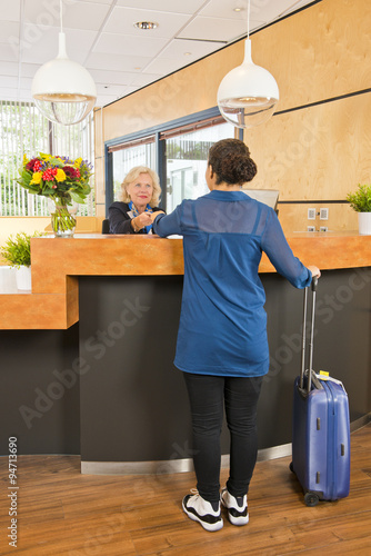 Young woman checking in at a hotel photo