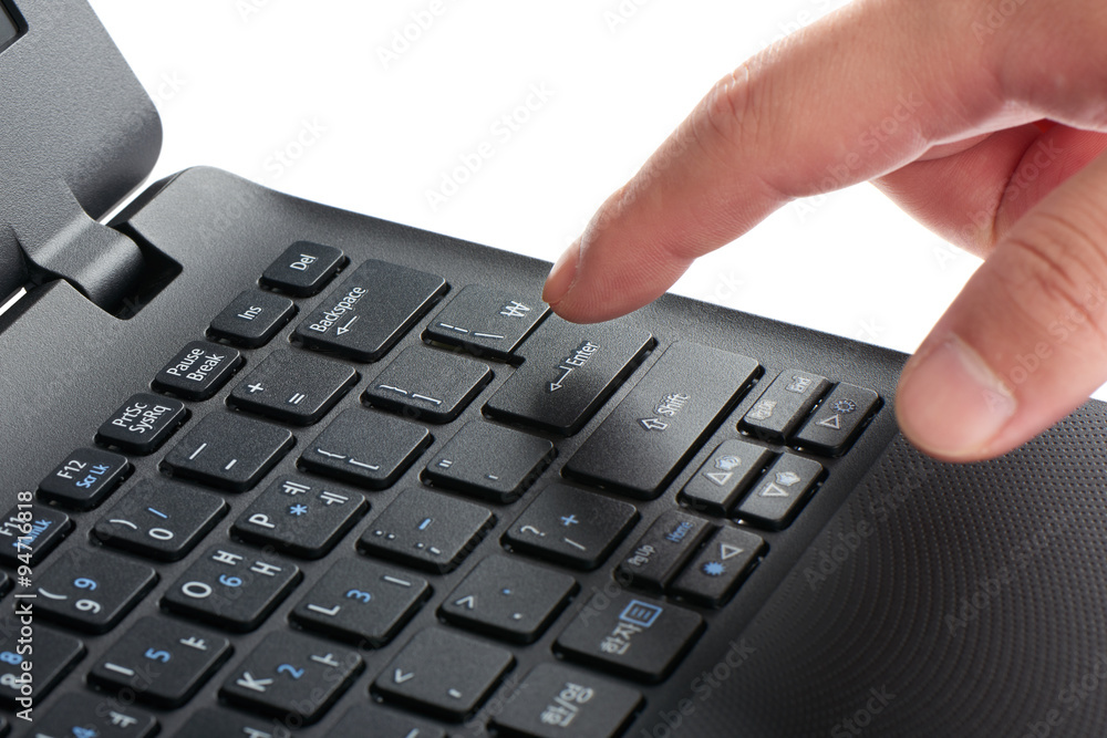 laptop keypad with index finger pressing enter key laptop keypad with index finger pressing enter key