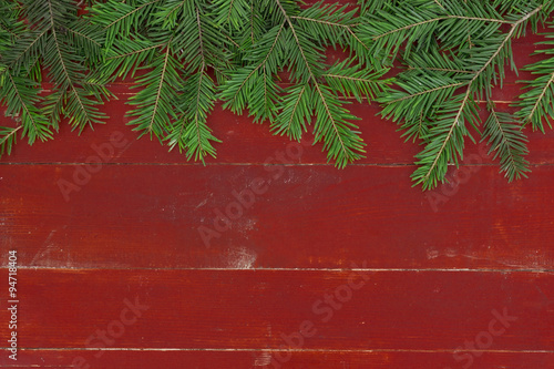 Christmas background

Christmas fir tree branches on a red background.
